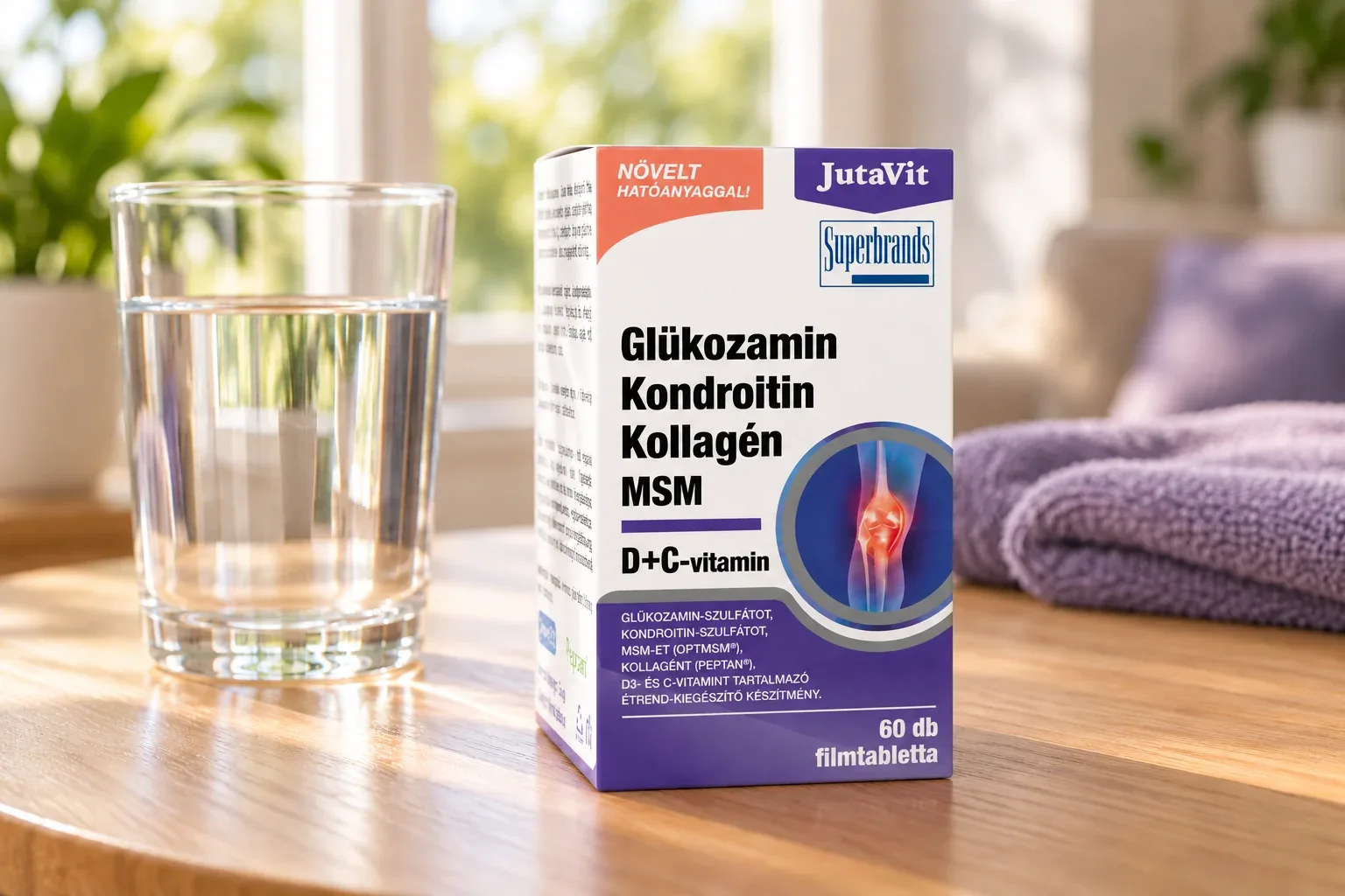 Škatuľka JutaVit pri pohári vody a zloženom uteráku v domácom prostredí
